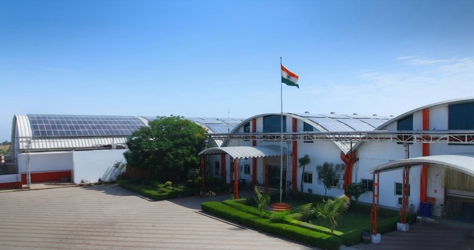 The Pegma Resources facility entrance in Ajmer, Rajasthan, the Indian flag flying above the forecourt